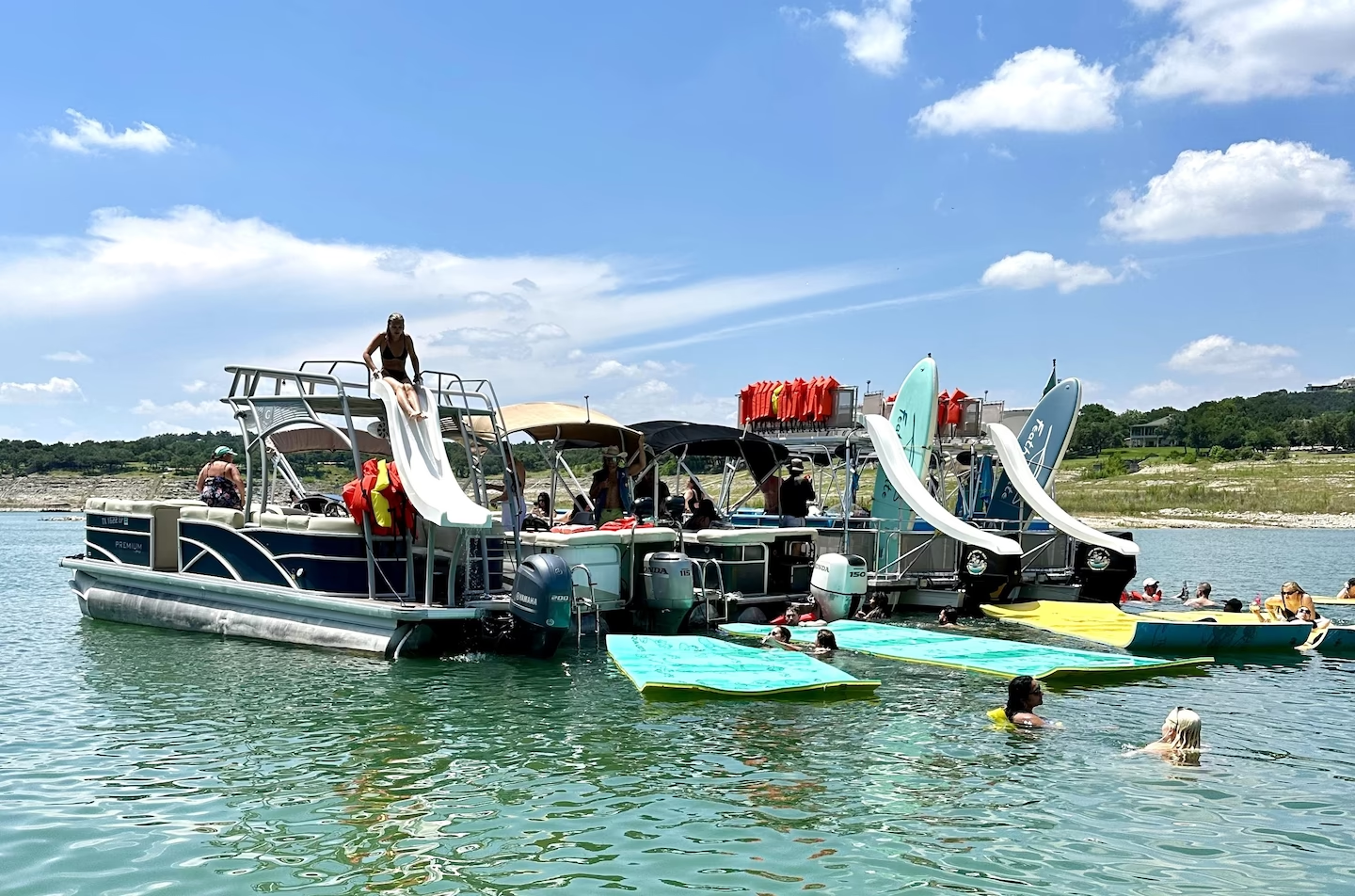 Pontoon boats with slides and lily pads on the lake